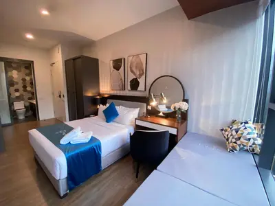 a hotel room with a bed and a desk at Ceylonz Lifestyle Suites @ Bukit Bintang in Kuala Lumpur