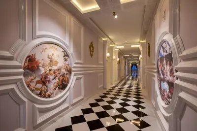 a hallway with paintings on the walls and a checkered floor at arte by Thomas Chan in Kuala Lumpur