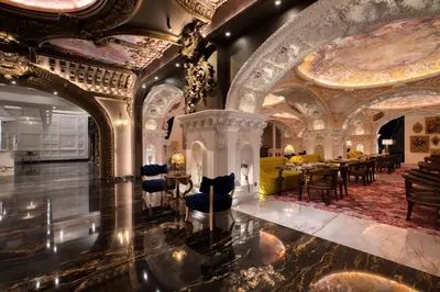 a lobby of a hotel with a room with tables and chairs at arte by Thomas Chan in Kuala Lumpur