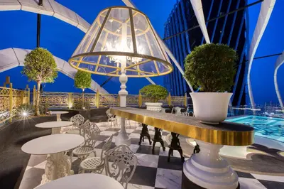 a view of a patio with tables and potted plants at arte by Thomas Chan in Kuala Lumpur