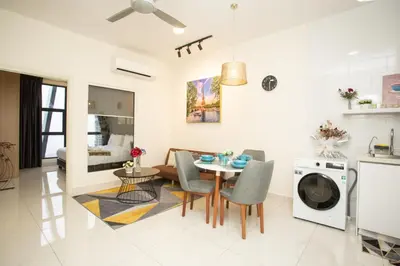a kitchen and living room with a table and chairs at ARTE MONT KIARA BY PSM Luxury Suites in Kuala Lumpur