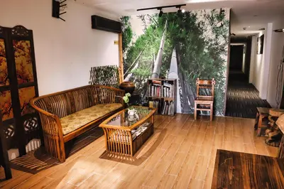 a living room with a couch and a table at Rain Forest Hotel in Kuala Lumpur