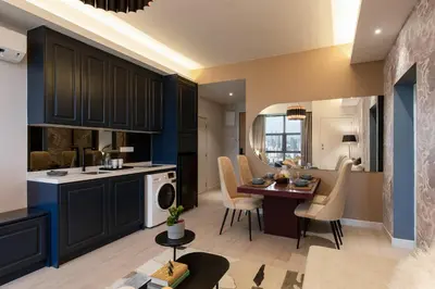 a kitchen and living room with a table and chairs at AMI Suites - Arte Mont Kiara in Kuala Lumpur