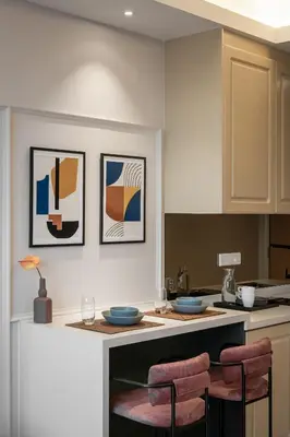 a kitchen with a counter with three pictures on the wall at AMI Suites - Arte Mont Kiara in Kuala Lumpur
