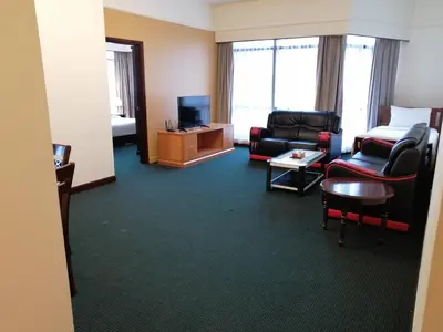 a living room with a couch chairs and a television at KL Time Square suit At Times square in Kuala Lumpur