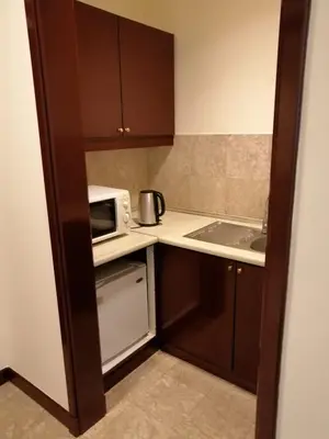 a small kitchen with a microwave and a sink at KL Time Square suit At Times square in Kuala Lumpur