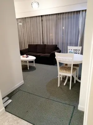 a living room with a couch and a table and chairs at KL Time Square suit At Times square in Kuala Lumpur