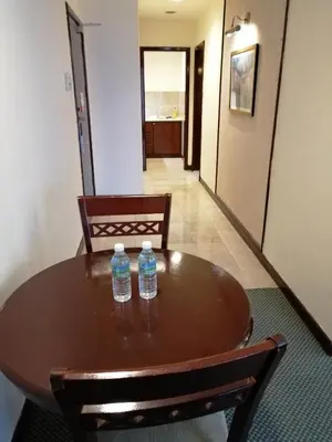 two water bottles sitting on top of a wooden table at KL Time Square suit At Times square in Kuala Lumpur