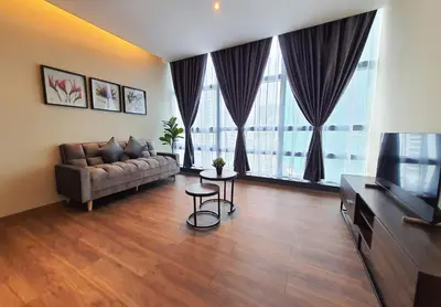 a living room with a couch and a television at Bangsar Trade Centre Kuala Lumpur by SkyLimit Suites in Kuala Lumpur