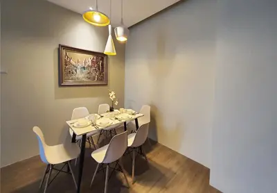 a dining room with a table and chairs at Bangsar Trade Centre Kuala Lumpur by SkyLimit Suites in Kuala Lumpur