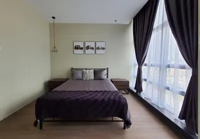 a bedroom with a bed and a large window at Bangsar Trade Centre Kuala Lumpur by SkyLimit Suites in Kuala Lumpur