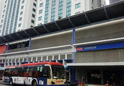 a bus is parked in front of a building at Bangsar Trade Centre Kuala Lumpur by SkyLimit Suites in Kuala Lumpur