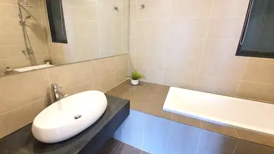 a bathroom with a sink and a bath tub at KLGateway Premium Residence Mid Valley in Kuala Lumpur