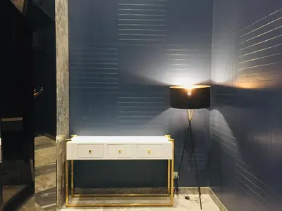 a room with a white dresser and a lamp at KLGateway Premium Residence Mid Valley in Kuala Lumpur