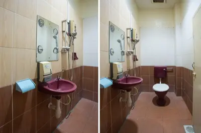 a bathroom with two sinks and a toilet at SPOT ON 90137 Casavilla Hotel Pudu in Kuala Lumpur