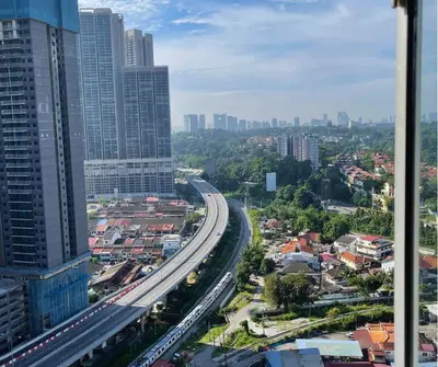 an overhead view of a city with a highway at Monkey Mansion in Kuala Lumpur