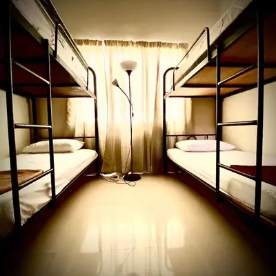 a room with two bunk beds and a lamp at Monkey Mansion in Kuala Lumpur