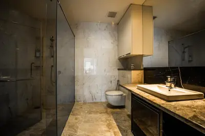 a bathroom with a sink and a shower and a toilet at Luxe Suites at Platinum KLCC in Kuala Lumpur