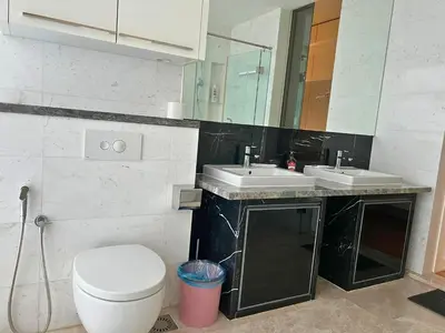 a bathroom with a toilet and a sink and a mirror at Luxe Suites at Platinum KLCC in Kuala Lumpur