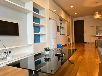 a living room with a tv and a glass table at Luxe Suites at Platinum KLCC in Kuala Lumpur