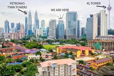 a city with skyscrapers and a city with buildings at Signature Apartment at Mercu Summer Suites KLCC in Kuala Lumpur