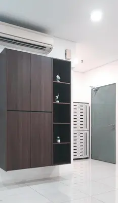 a brown cabinet with shelves in a room at Signature Apartment at Mercu Summer Suites KLCC in Kuala Lumpur