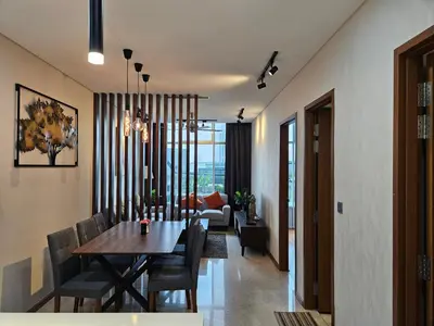 a dining room and living room with a table and chairs at Sky Suites KLCC by Asiapex in Kuala Lumpur