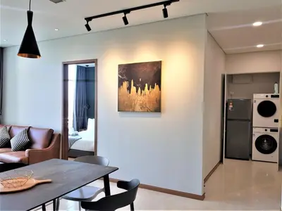 a dining room and living room with a table at Sky Suites KLCC by Asiapex in Kuala Lumpur
