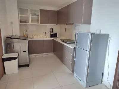 a kitchen with a refrigerator and a counter top at Wonderful KLCC View at Regalia Suites in Kuala Lumpur