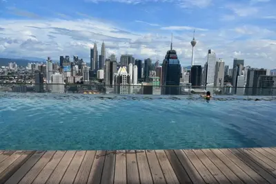 a pool on the roof of a building with a city at Wonderful KLCC View at Regalia Suites in Kuala Lumpur