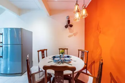 a dining room with a table and a refrigerator at 3BR Family-Friendly Landed House,PandanPerdana,KL by Verano in Kuala Lumpur