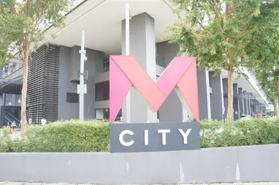 a city sign in front of a building at M City Lake View 1+1 Room in Kuala Lumpur