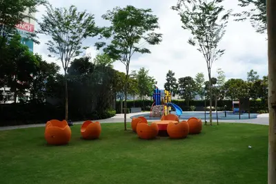 a playground in a park with orange plastic animals at M City Lake View 1+1 Room in Kuala Lumpur