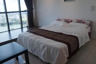 a bed in a room with a large window at M City Lake View 1+1 Room in Kuala Lumpur
