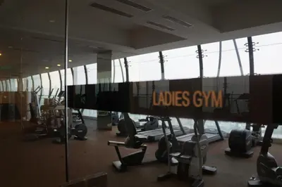 a gym with a lot of chairs and a large window at M City Lake View 1+1 Room in Kuala Lumpur