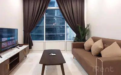 a living room with a couch and a tv at Sky Suites KLCC by iRent365 in Kuala Lumpur