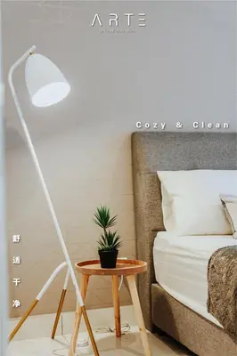 a white floor lamp next to a bed and a table at Arte Mont Kiara Luxury Suite with Heated Jacuzzi Pods - Free Parking - Next to MITEC- by The Stay Hub in Kuala Lumpur