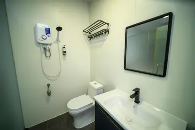 a bathroom with a toilet and a sink and a mirror at Hotel LBS in Kuala Lumpur