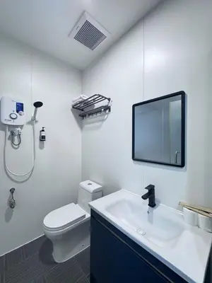 a bathroom with a toilet and a sink and a mirror at Hotel LBS in Kuala Lumpur