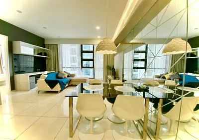 a living room with a dining table and chairs at Robertson PanoramaKL Suites in Kuala Lumpur