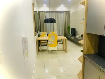 a dining room with a table and yellow chairs at Robertson PanoramaKL Suites in Kuala Lumpur