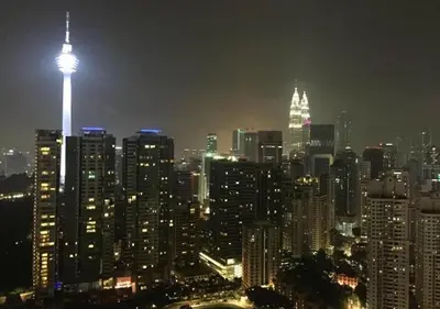 a view of a city at night with a tall building at Robertson PanoramaKL Suites in Kuala Lumpur
