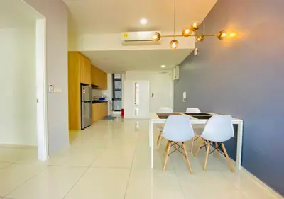 a dining room with a table and white chairs at Robertson PanoramaKL Suites in Kuala Lumpur