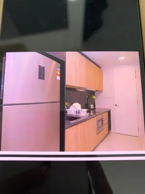 a view of a kitchen with a refrigerator at Robertson PanoramaKL Suites in Kuala Lumpur