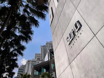 a building with a sign on the side of it at Soho Suites KLCC by Rest Kuala Lumpur in Kuala Lumpur