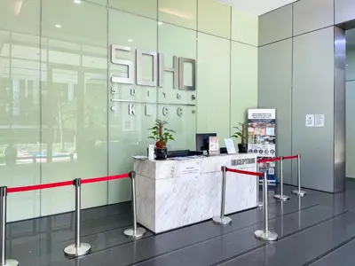 a lobby with a counter with a red ribbon at Soho Suites KLCC by Rest Kuala Lumpur in Kuala Lumpur