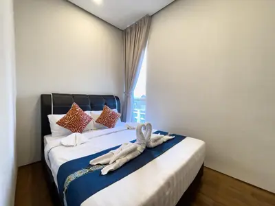 a bedroom with a bed with towels on it at Soho Suites KLCC by Rest Kuala Lumpur in Kuala Lumpur
