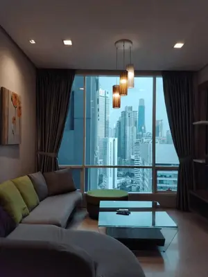 a living room with a couch and a large window at Soho Suites KLCC by Rest Kuala Lumpur in Kuala Lumpur