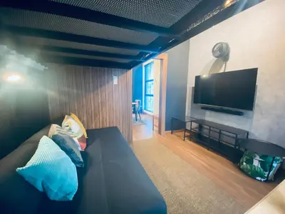 a living room with a couch and a flat screen tv at Arte Mont Kiara by RKD HOME in Kuala Lumpur