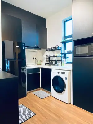 a kitchen with a refrigerator and a washing machine at Arte Mont Kiara by RKD HOME in Kuala Lumpur